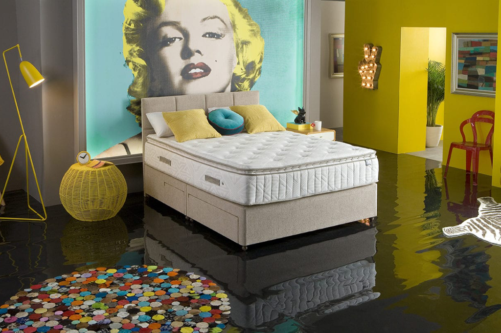 image of a king koil mattress in a bright hotel room